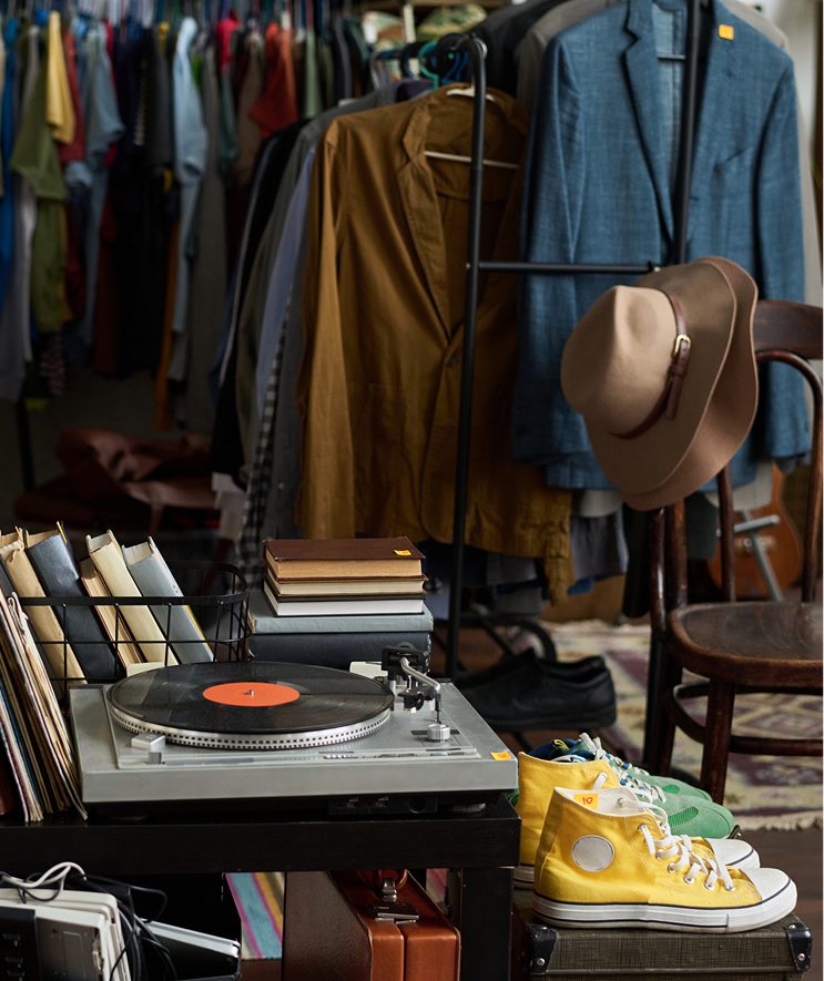 garage sale objects, clothes on a rail, shoes, hats