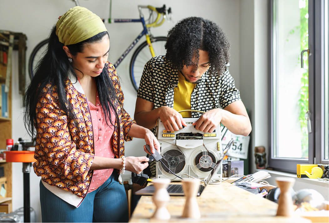 Two people with an old radio