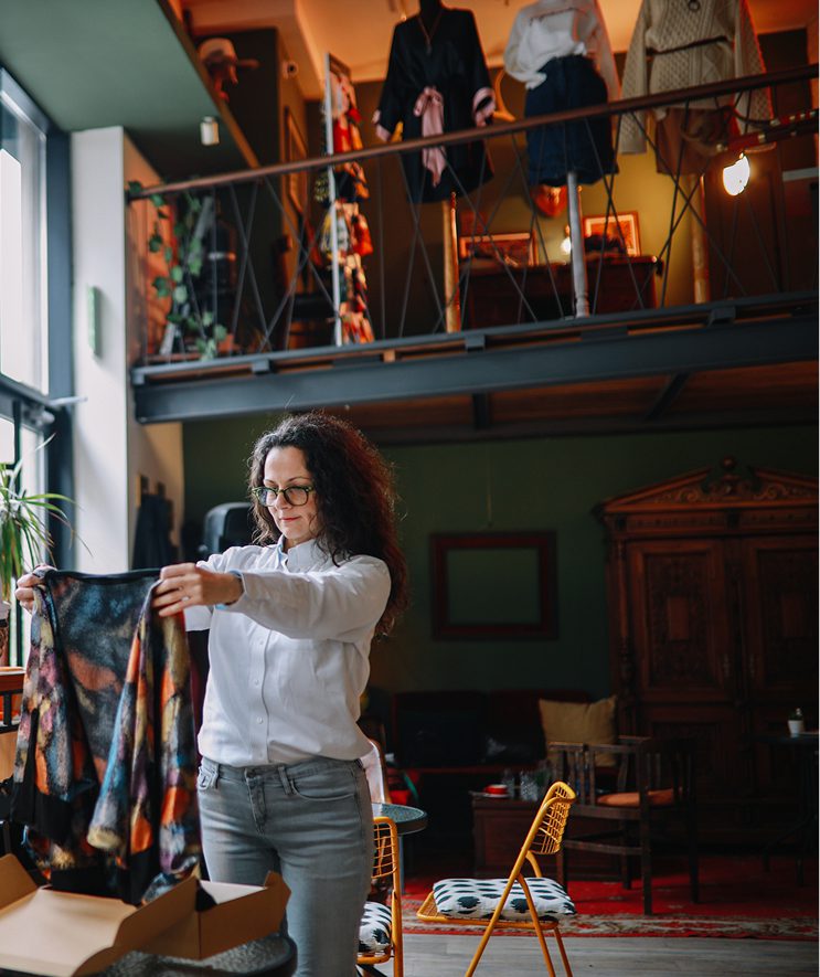 woman inspecting a clothing item