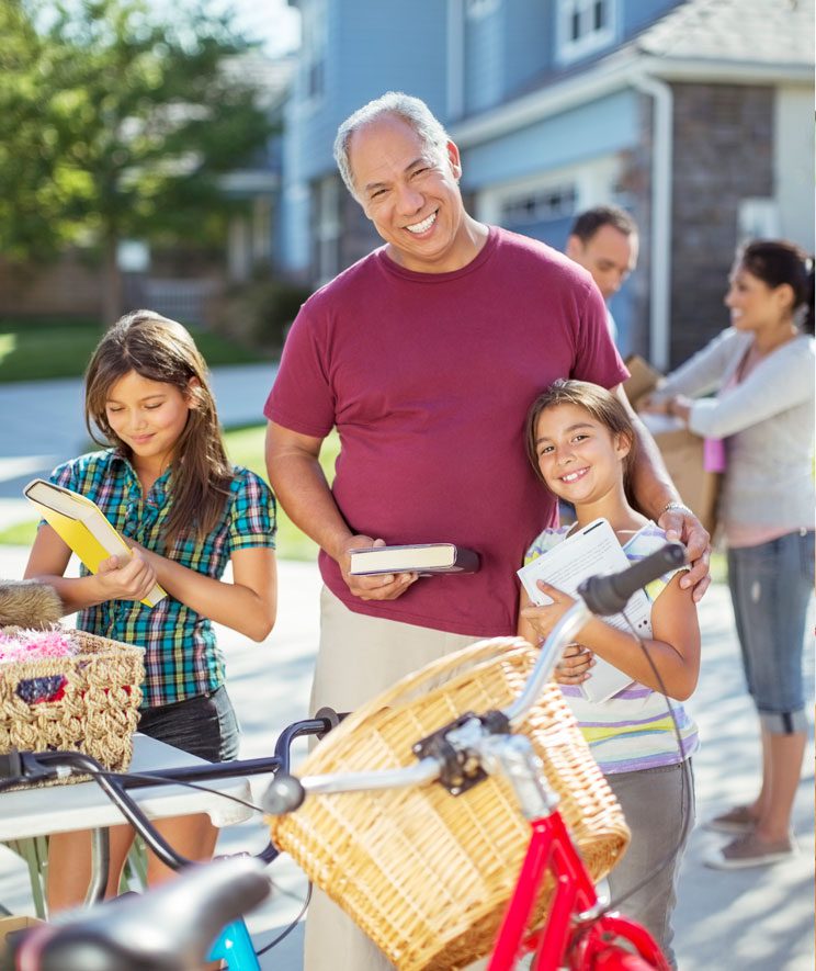 Portrait of grandfather and granddaughter at yard sale