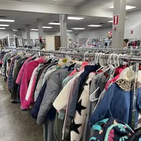 Clothing racks with colorful coats in store.