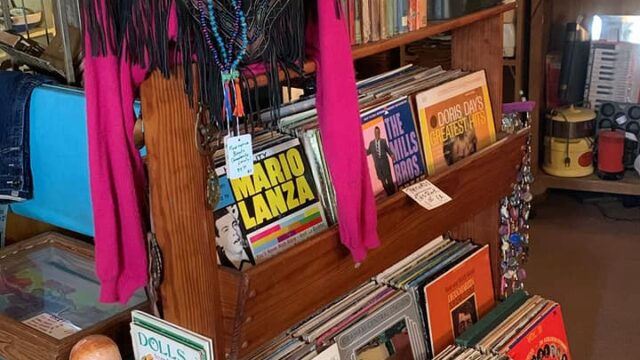 Vintage store with mannequin and vinyl records.