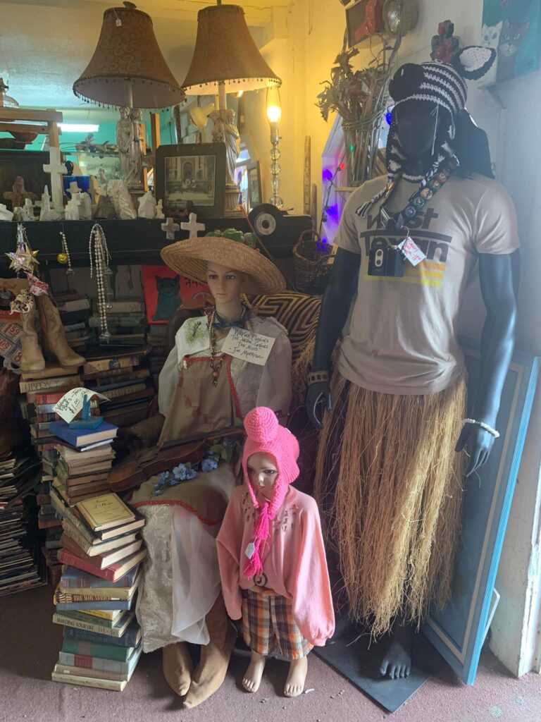 Mannequins dressed in eclectic, cultural attire display.