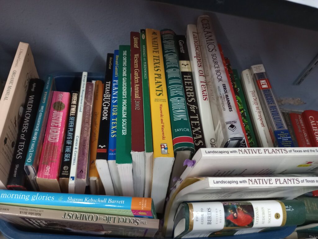 Books on Texas plants and ceramics collection.